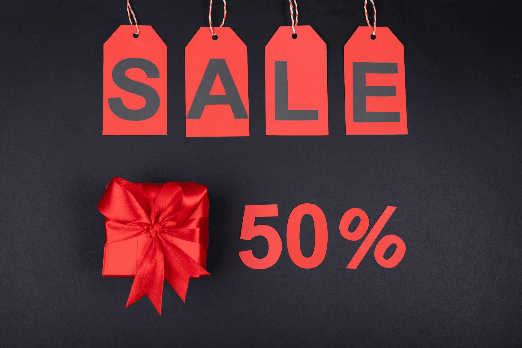 Red sale tags and a gift advertising a fifty-percent discount